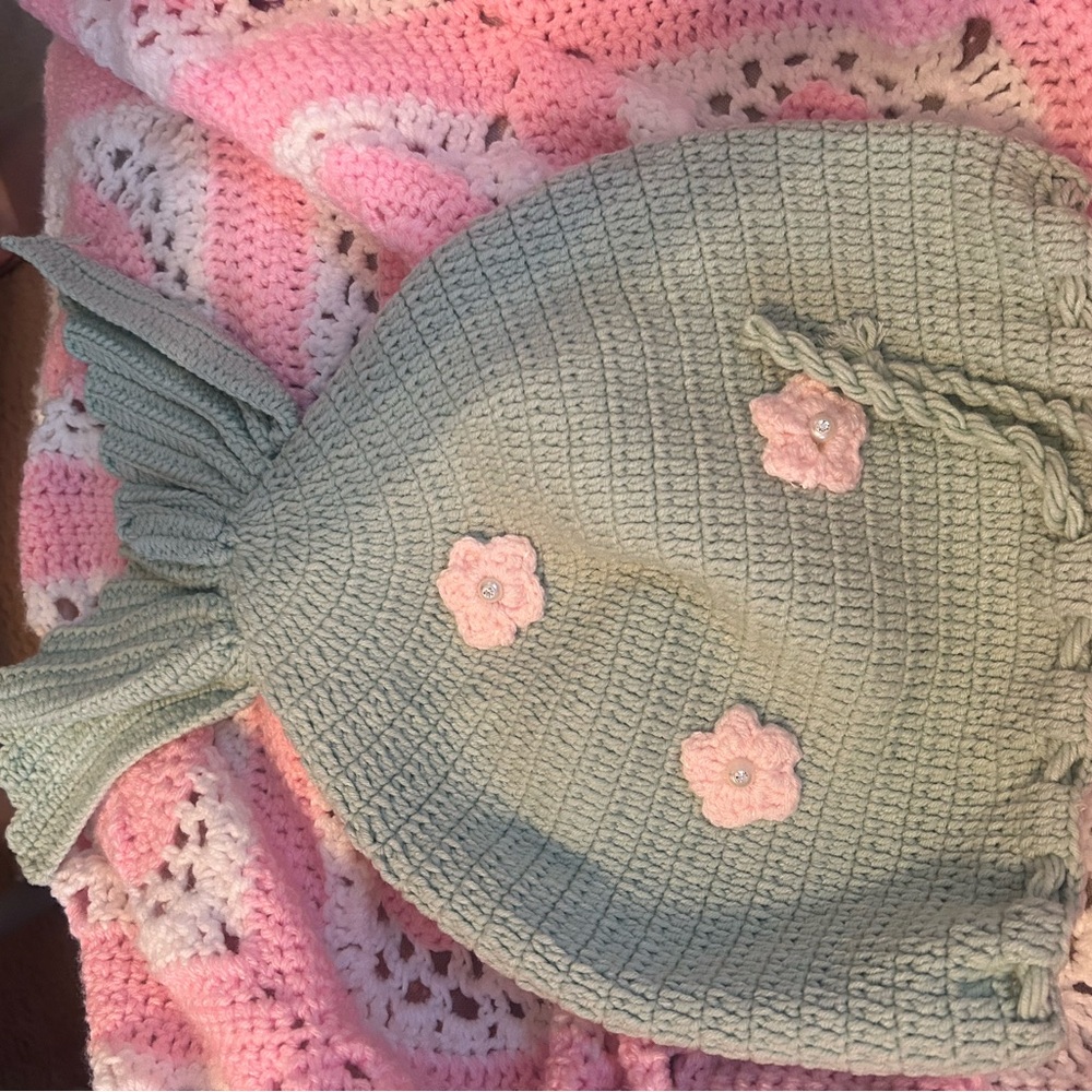 Green Knit Baby mermaid tail with Pink Flower Accents. Used for baby pictures.